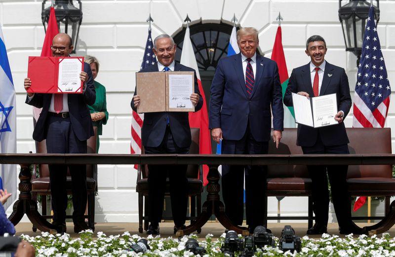 Bahrain’s Foreign Minister Abdullatif Al Zayani, Israel's Prime Minister Benjamin Netanyahu and United Arab Emirates (UAE) Foreign Minister Abdullah bin Zayed display their copies of signed agreements while President Trump looks on, at a ceremony of the Abraham Accords at the White House Sep. 15. Photo: Tom Brenner/Reuters