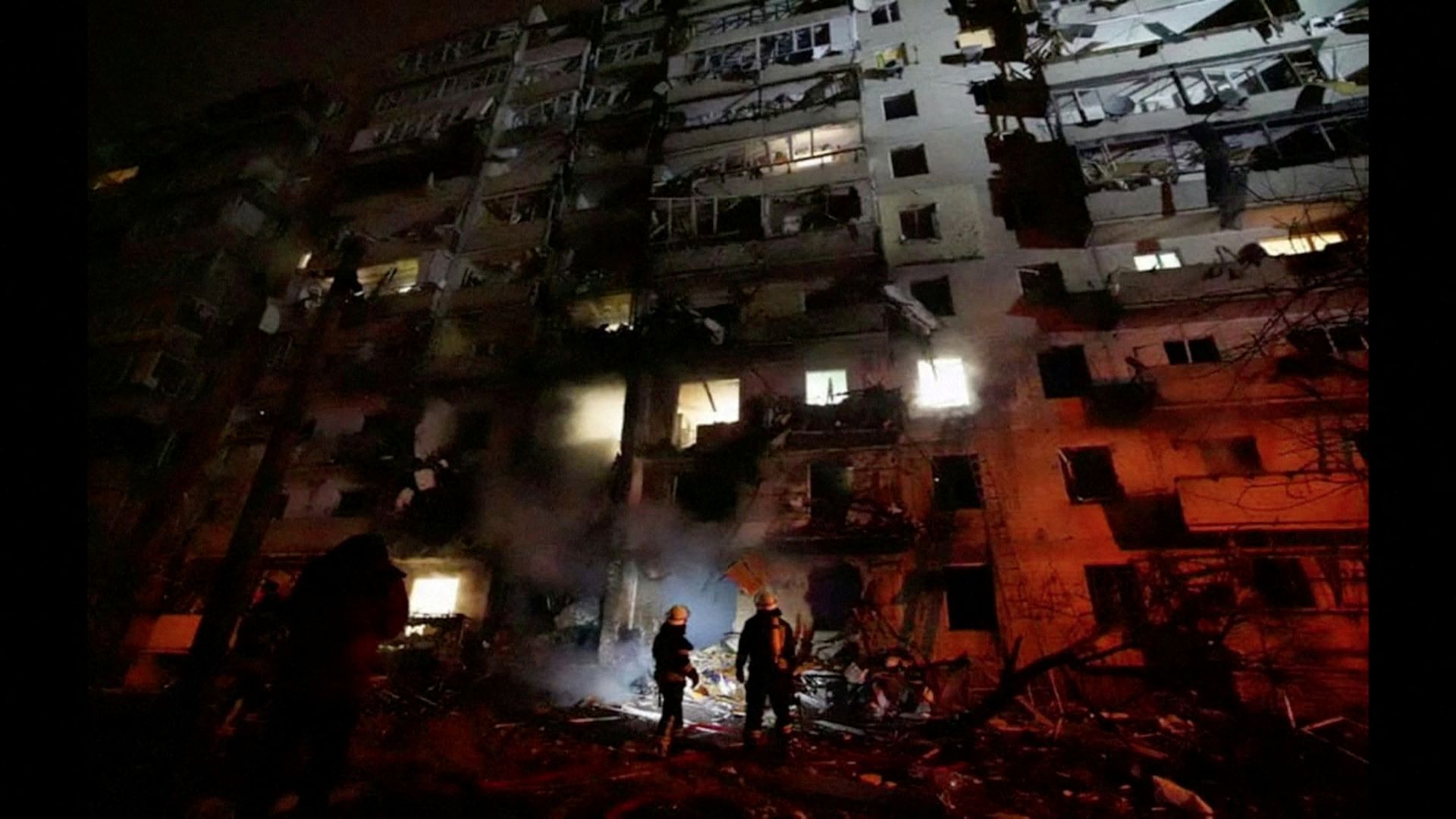 Firefighters work at the site of a damaged residential building, after Russia launched a massive military operation against Ukraine, in Kyiv, Ukraine, Feb. 25, 2022. Screengrab: Ukrainian Ministry of Emergencies/via Reuters