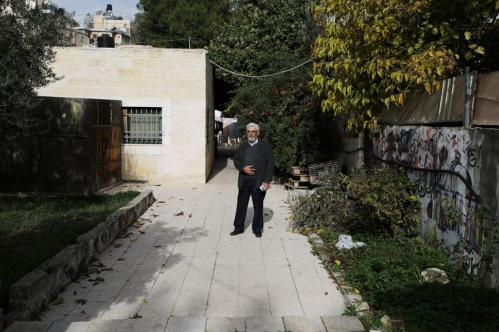 Palestinian Nabil Al-Kurd stands outside his home in east Jerusalem December 14, 2020. Picture taken December 14, 2020. REUTERS/Ammar Awad