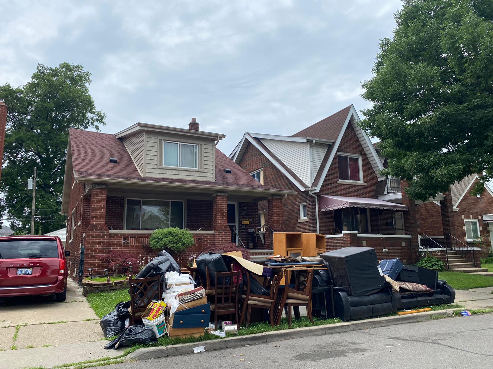 Heaps of damaged furniture from the flooding sits on the curb and overflow the city streets, waiting for emergency trash pick up. Photo: Imad Mohamad / The Arab American News