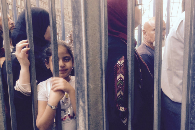Palestinians waiting at Qalandia Checkpoint