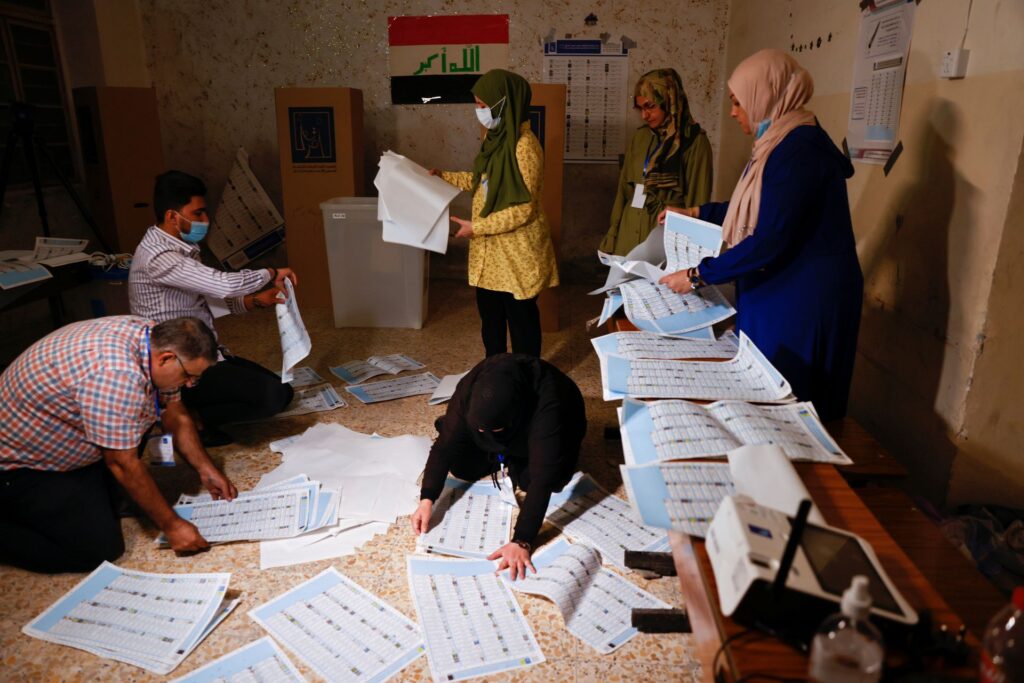 Officials work at a polling station during the parliamentary election, in Baghdad, Iraq, Oct. 10. Photo: Thaier al-Sudani/Reuters