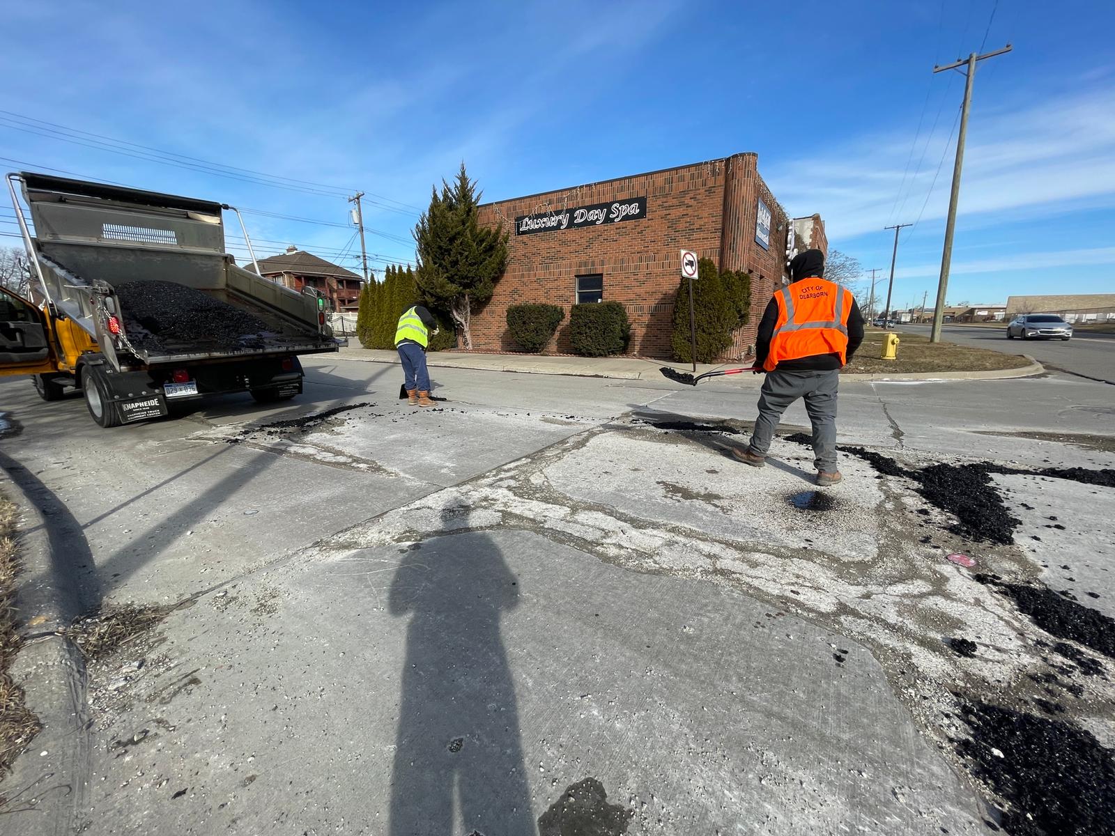 A city of Dearborn road maintenance crew fills out damaged segments Miller Road, Thursday, March 3. Photo: Imad Mohamad/The Arab American News