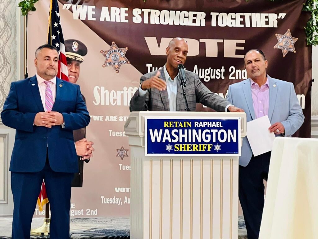Wayne County Sheriff Raphael Washington speaking at the fundraising event and to his left Undersheriff Mike Jaafar and to his right Wayne County Deputy Director of Homeland Security Sam Jaafar, in Dearborn, Wednesday, May 18.