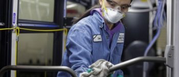 Vehicle maintenance utility service worker Thiphavanh 'Loui' Thepvongsa wipes down an off-duty bus with disinfectant in Seattle, Washington.PHOTO BY REUTERS