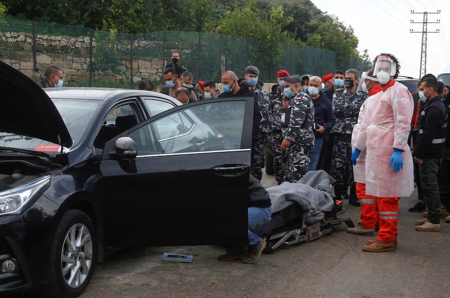 Security personnel gather as medics remove the body of Lebanese activist Lokman Slim from the car in which he was found dead in southern Lebanon on Feb. 4, 2021. Photo: Mahmoud Zayyat/AFP/Getty