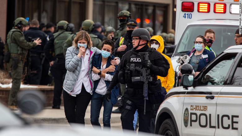 Police escort people at the scene of an active shooter at a grocery store in Boulder, Colorado. Photo: Getty Images