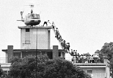 An Air America helicopter crew member helps evacuees up a ladder on the roof of 18 Gia Long Street on April 29, 1975, shortly before the city fell to advancing North Vietnamese troops. Photo: Hugh Van Es