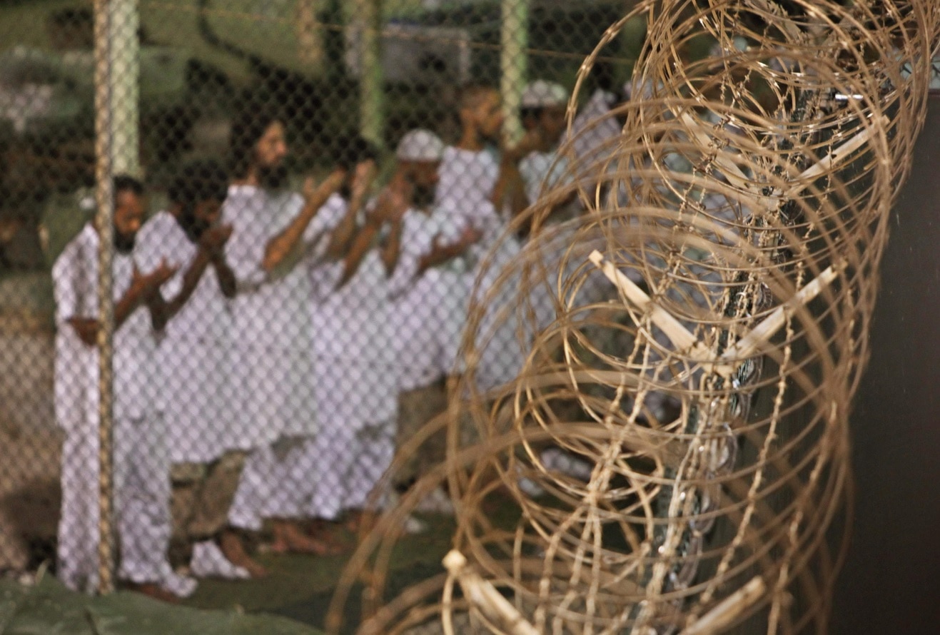 Detainees praying before dawn inside Camp 4 detention facility at Guantanamo Bay, Cuba. Photo: AAP