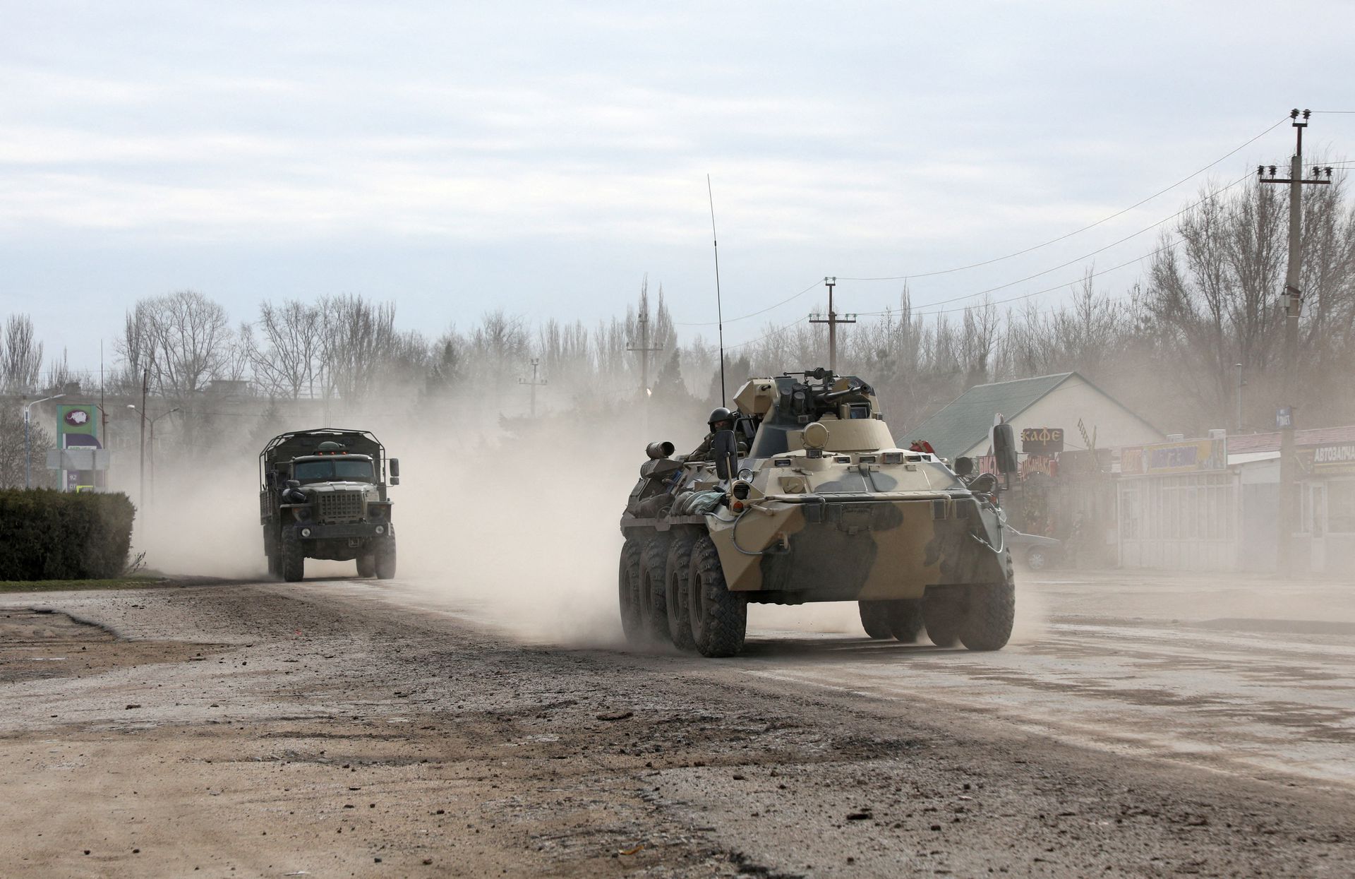 Russian Army military vehicles drive along a street, after Russian President Vladimir Putin authorized a military operation in eastern Ukraine, in the town of Armyansk, Crimea, Feb. 24. Photo: Reuters/Stringer