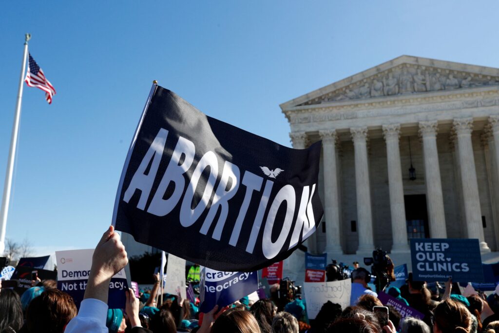 A demonstrator holds up an abortion flag outside of the U.S. Supreme Court as justices hear a major abortion case on the legality of a Republican-backed Louisiana law that imposes restrictions on abortion doctors, on Capitol Hill in Washington D.C., March 4, 2020. Photo: Tom Brenner/Reuters