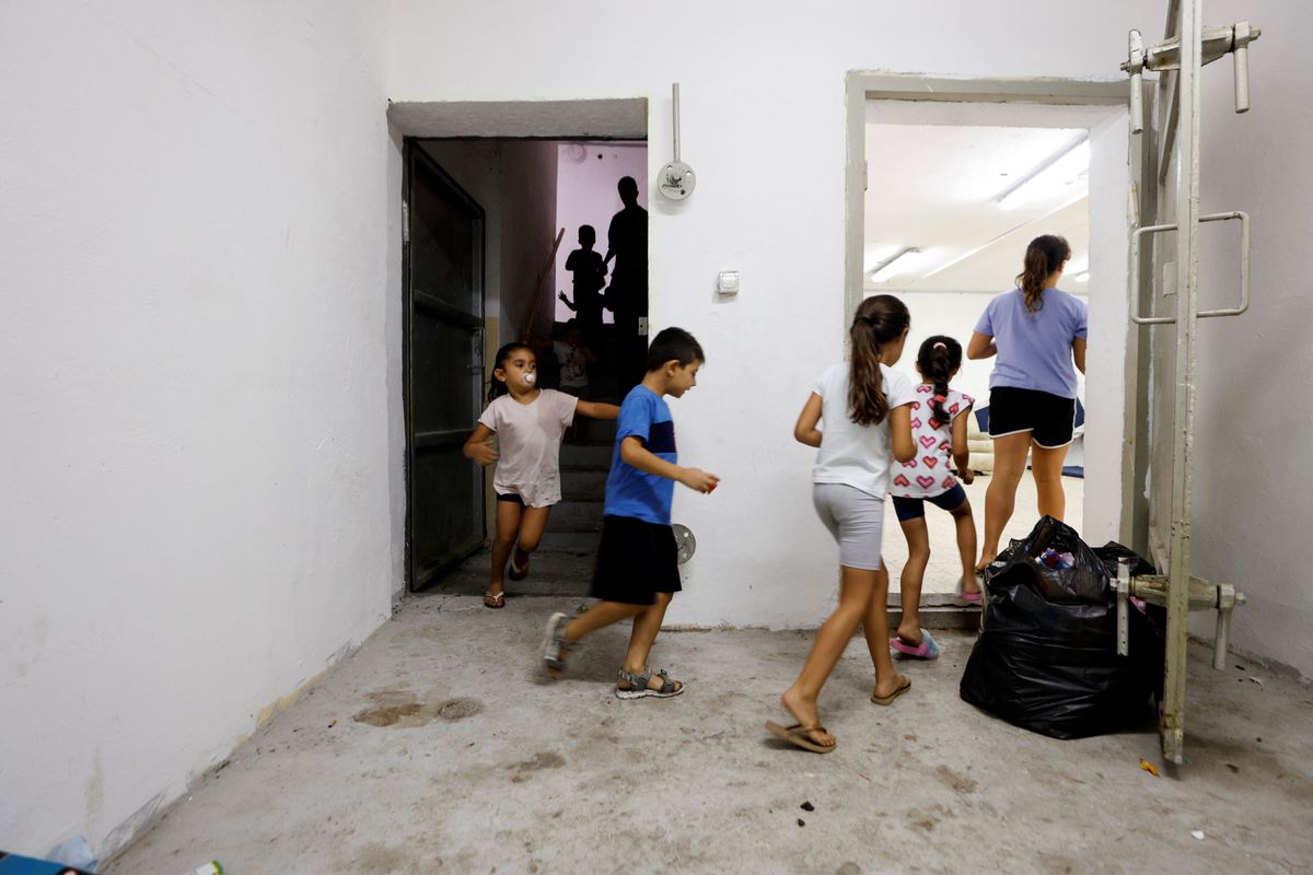 Israeli children run inside a bomb shelter as a siren goes off indicating incoming rockets fired from Gaza towards Israel, in Ashkelon, Israel Aug 7. Photo: Reuters