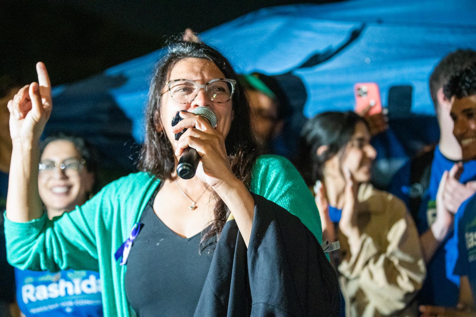 District 12 incumbent candidate Rashida Tlaib speaks to a crowd of supporters and volunteers on Grand River Avenue by the North Rosedale Park neighborhood in Detroit on election night, Aug. 2