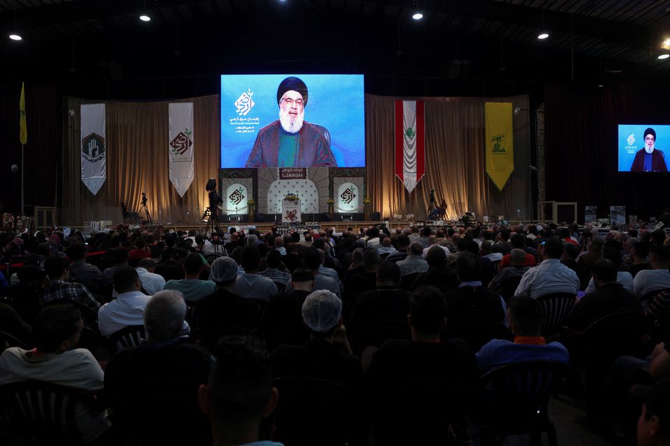 Lebanon's Hezbollah leader Sayyed Hassan Nasrallah addresses his supporters through a screen during the opening of a local exhibition, in Beirut's southern suburbs, Lebanon Oct. 27. Photo: Mohamed Azakir/Reuters